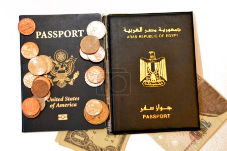 Egyptian passport, Egypt's money banknotes pounds, American passport, USD dollars and coins change, United States of America Traveler ID and Arab Republic of Egypt, travel tourism concept