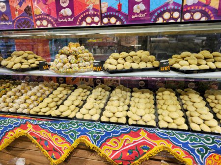 Téléchargez les photos : Le Caire, Égypte, 24 mars 2024 : biscuits arabes traditionnels pour la célébration des fêtes islamiques Fête d'El-Fitr, Ghoriba égyptienne, Kahk égyptien au sucre en poudre, petit four (mignardises) au chocolat - en image libre de droit