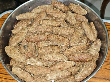 Arabic cuisine traditional food beef Kofta, kebab kofta shish which is minced meat grilled or cooked, oriental grilled barbecued meat food, tray of kofta cooked and ready to be served