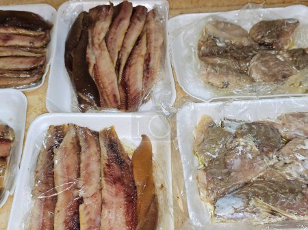hot smoked herring fish fillets and soft roe prepared with oil and lemon and Fesikh which is fermented, salted and dried gray mullet fish of the genus Mugil, a traditional celebratory of ancient Egypt
