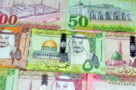 Photo for Background of Saudi Arabia money banknotes bill of different values, 100, 50, 10 and 5 riyals of King Salman Bin AbdulAziz Al Saud era, Saudi money exchange rate and economy status, pile of riyals - Royalty Free Image