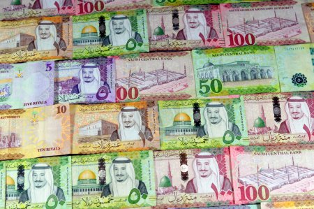 Photo for Background of Saudi Arabia money banknotes bill of different values, 100, 50, 10 and 5 riyals of King Salman Bin AbdulAziz Al Saud era, Saudi money exchange rate and economy status, pile of riyals - Royalty Free Image