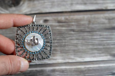 Translation of the Arabic Text (Allah, God) on a silver precious metal piece with precious stones, exchange rate marketing and value, business, price of silver concept, an investment, store of value