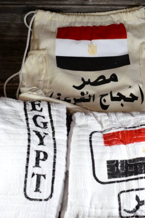 Translation of Arabic (Egypt, pilgrimage lottery) Ihram clothing Ahram with the Egyptian flag, worn by Muslim people while in a state of Iram, during either of the Islamic pilgrimages, Hajj and Umrah