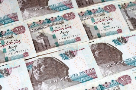 Montón de moneda egipcia de 100 EGP LE billetes de cien libras egipcias, gastos, dar y usar el concepto de dinero, pagar y comprar con billetes de banco con la mezquita Sultan Hassan y la Esfinge