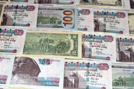 Los billetes en moneda egipcia de 100 EGP LE billete de cien libras y USD en efectivo estadounidense de billetes de dólares, los tipos de cambio de Egipto y Estados Unidos de América, la inflación y el concepto de economía