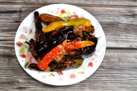 Pickled roast fried aubergine and green peppers stuffed with garlic, chili red pepper,vinegar, lemon, coriander, parsley, chopped tomatoes and spices, marinated Egyptian eggplant pickles