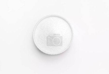 Photo for Isolated natural sweetener Erythritol, produced by fermentation from corn, called dextrose in ceramic bowl on white background. Sugar substitute. Horizontal plane, copy space for text,top view. - Royalty Free Image