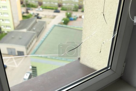 Photo for Crack, Broken Glass In A Double-glazed Window Due To Manufacturing Defect In Building, Home. Manufacturers Defect, Defective Products. Warranty. Horizontal Plane. Closeup. High quality photo - Royalty Free Image