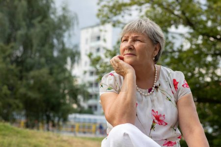Photo for Portrait Of Real Senior Caucasian Woman With Gray Hair Sits In Park. Serious, puzzled, worried 70 Yo Mature Female, Retirement. Healthcare Lifestyle, Wellness Of Elderly Lady. Horizontal Copy Space - Royalty Free Image