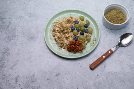 Superfood. Healthy Breakfast, Oatmeal Porridge With Hemp Protein Powder, Nuts, Berries, Bowl With Plant-derived Protein From Cannabis Plant, Spoon. Copy Space. Meal. Horizontal Plane.