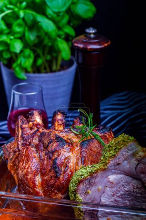 Photo for Roast pork knuckle with spices and herbs on a black background - Royalty Free Image