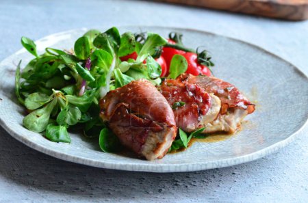 Saltimbocca. Veal schnitzel with sage and Parma ham. Italian specialty. Front view.