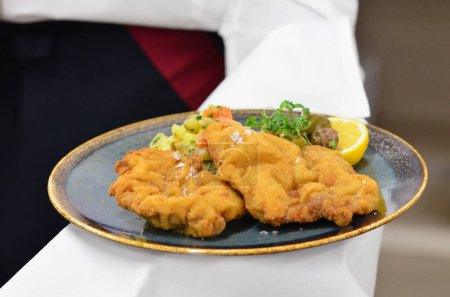 deep fried fish with shrimp, view of served veal steak from liver, Czech traditional food, restaurant background, close-up view