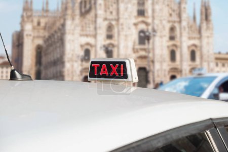 White taxi, Milan, central district, Duomo Cathedral. Italian taxi cab.