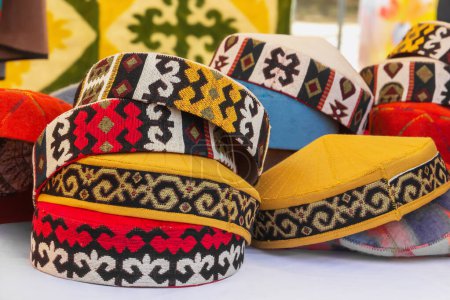 Téléchargez les photos : Chapeaux asiatiques traditionnels à partir d'un feutre multicolore avec un fil brodé de couleur d'ornement national. Gros plan - en image libre de droit
