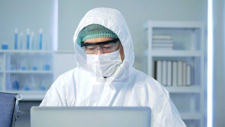 Photo for Asian man scientist analysis results in the laboratory. Young scientist doing some research. He's Conducts Experiments in Modern Laboratory - Royalty Free Image