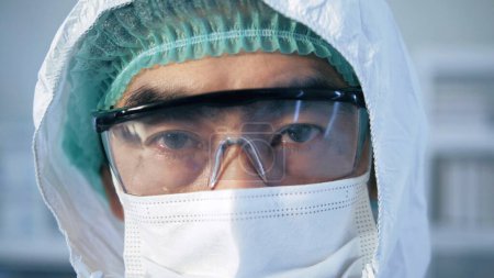 Photo for Portrait of confident Asian doctor man face look at camera, close-up. eyes with safety glasses and protective mask. Research Laboratory Officer. 2019 Novel Coronavirus (2019-nCoV), COVID-19, pandemic - Royalty Free Image
