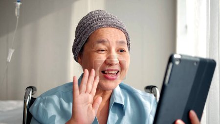 Photo for Happy Asian elderly patient sitting on wheelchair and making video call with tablet at hospital. elderly people healthcare concept - Royalty Free Image