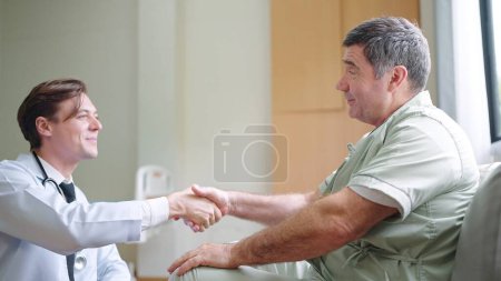 Photo for Doctor give help support handicapped old patient happy sitting in hospital or home health care, doctor caregiver or nurse assist take care of smiling senior disabled grandfather, elderly healthcare - Royalty Free Image