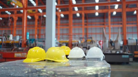 Photo for Close up of white and yellow safety helmets on the table at industry factory. Safety helmets on table for construction safety. Security concept - Royalty Free Image