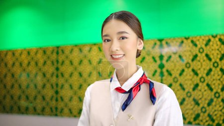 Photo for Asian female airline worker stewardess in aviation air hostess uniform looking at camera and smiling - Royalty Free Image