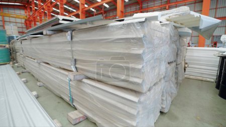Photo for Close up stack of roofing sheets in metal sheet factory. Metal sheet roof silver colour at warehouse metal roofing factory. Metal sheet roof equipment - Royalty Free Image