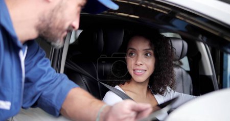 Photo for Beautiful woman in car talking with automotive mechanic man after successful of checking and maintenance car engine in mechanics garage. Vehicle service - Royalty Free Image