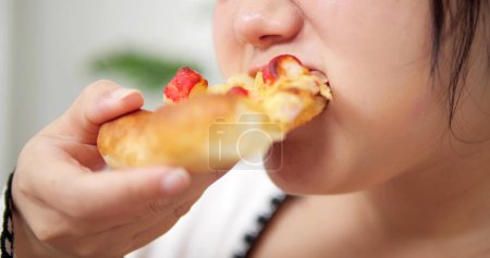 Photo for Close up face of hungry woman enjoying eating tasty pizza. Fat woman enjoys Italian pizza. Junk food is unhealthy concept - Royalty Free Image