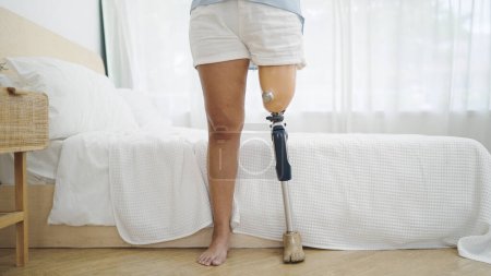 Photo for Close up leg prosthetic equipment of amputee standing at bedroom. Difficulties in disabled people life, Physical disability, Leg prosthetic equipment, Amputee concept - Royalty Free Image