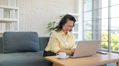 Photo for Overworked elderly woman suffering from blurred eyesight after using laptop. Tired adult women suffers from eyestrain. Eye strain problem concept - Royalty Free Image