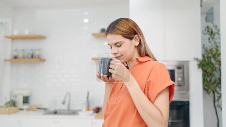 Photo for Happy young woman enjoy drinking a cup of tea heaping or coffee in the morning at home. Beautiful young woman holding a coffee cup and enjoy drinking. Lifestyle concept - Royalty Free Image