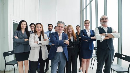 Photo for Successful multiethnic businessteam standing with arms crossed at modern office. Happy diverse professional business team standing in office looking at camera. Human resource concept - Royalty Free Image