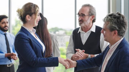 Photo for Caucasian man leader introducing woman manager to new team partner at seminar of company. Male leader introducing woman manager shaking hands welcoming newcomer - Royalty Free Image