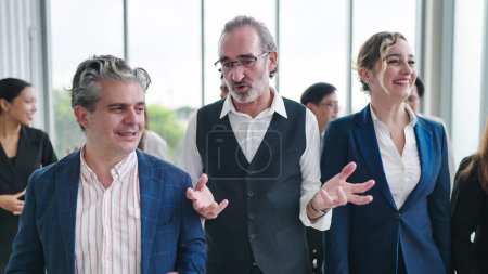 Photo for Group of diverse business people talking while walking together at modern office. Group of diverse coworkers discussion while walking the corridor in office together. Multiethnic business people group - Royalty Free Image