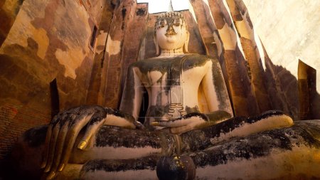 Téléchargez les photos : Wat Si Chum au parc historique de Sukhothai. Majestueux Bouddha assis de Wat Sri Chum à Sukhothai, Thaïlande. Site classé au patrimoine mondial de l'UNESCO. Sites anciens à Sukhothai, Thaïlande. Concept de voyage - en image libre de droit