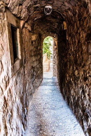 Small stone street like a tunnel in Dubrovnik, Croatia.