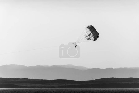 Photo for A couple parasailing at sunset in Adriatic sea coast, Croatia. - Royalty Free Image