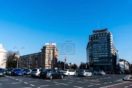 Photo for BUCHAREST, ROMANIA - MARCH 19, 2023: Victory square with Regina Maria and Superbet logos on the residential buildings. - Royalty Free Image