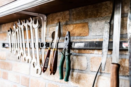 Photo for REGHIN, ROMANIA - JUNE 27, 2023: Wall with various carpentry tools. - Royalty Free Image
