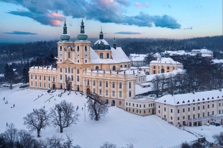 Photo for Winter, aerial view of the Pilgrimage church of Minor Basilica of the Visitation of the Virgin Mary covered with snow. A pilgrimage site, children playing, Moravia. Czech republic. - Royalty Free Image