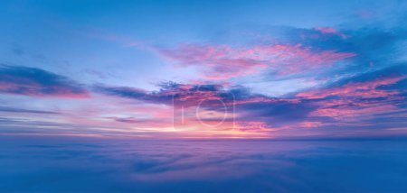 Photo for Ideal for Sky replacement project: Panoramic, colorful pink-orange-blue dramatic sky with clouds illuminated by red sunset, aerial photography, far horizon without obstacles. - Royalty Free Image