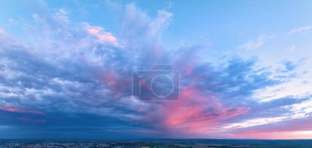 Photo for Sky replacement: Panoramic, colorful pink-orange-blue dramatic sky with clouds  illuminated by red sunset, aerial photography, far horizon without obstacles. Ideal for sky exchange projects. - Royalty Free Image