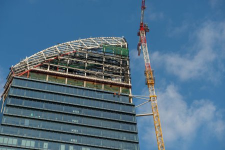 Photo for Milano Italia 4 dicembre 2019:Crane completing the skyscraper La Torre Libeskind or Torre PwC which is part of the CityLife project - Royalty Free Image