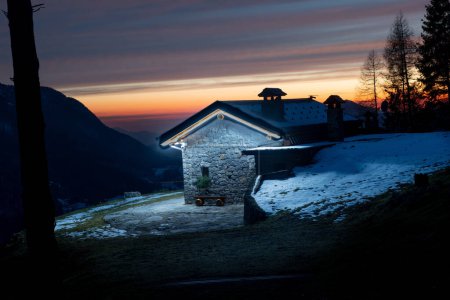 Téléchargez les photos : Illuminated mountain hut at sunset - en image libre de droit