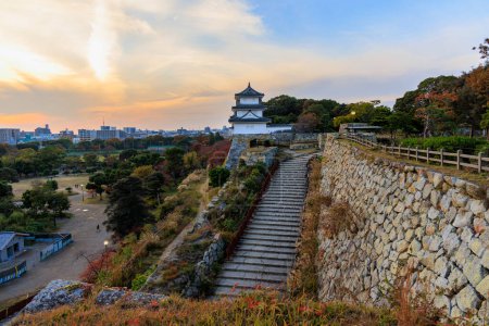 Photo for Stairs to castle lookout atop stone wall over city at sunset. High quality photo - Royalty Free Image