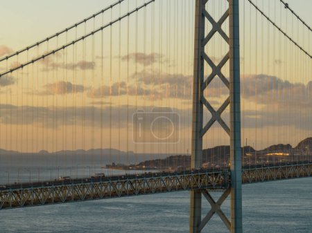 Photo for Light traffic on suspension bridge with beautiful clouds at sunrise. High quality photo - Royalty Free Image