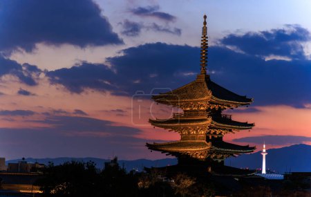 View from Higashiyama of Yasaka Pagoda and distant Kyoto Tower as sun sets. High quality photo