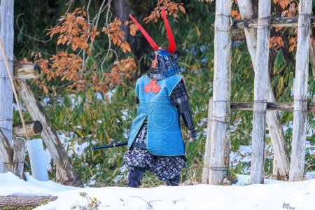Foto de Man dressed for battle in traditional samurai style walks through snow. High quality photo - Imagen libre de derechos