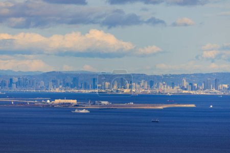 Photo for Kobe Airport on Manmade Island at Sea Level with City Skyline in Distance. High quality photo - Royalty Free Image